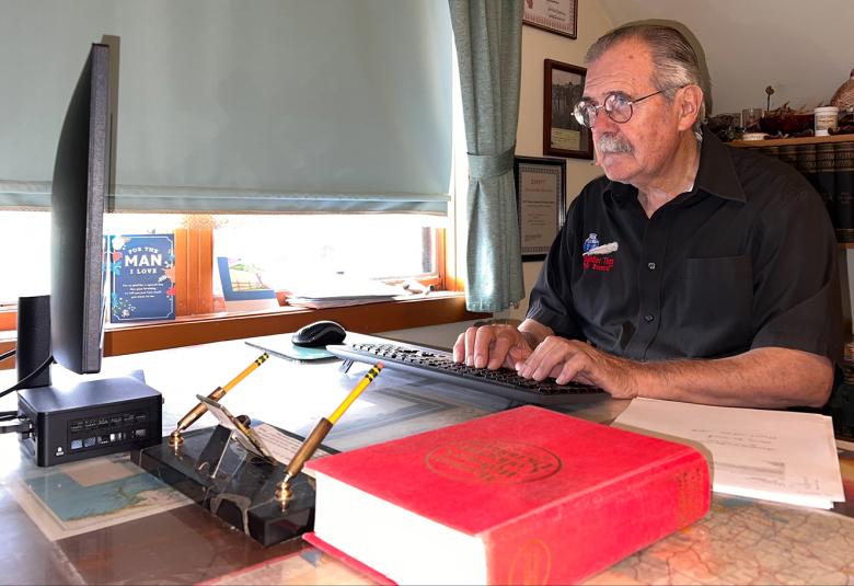 John Mutter writes at his computer at home. The local author researched and compiled a 19-page document highlighting the murder of Sherry Sumnicht in 1975. Her killer has never been brought to justice.  (Contributed)