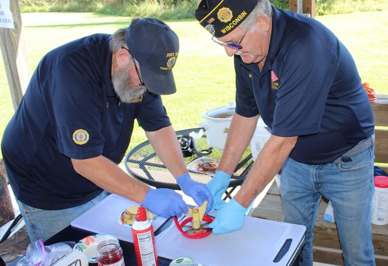 Tigerton American Legion Post 239 members Dave Jensen, left, and Ron Van Price prepare more apples for their caramel apple sale at Applefest on Sept. 27.